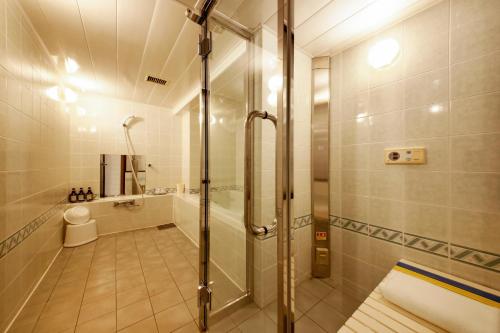 a bathroom with a shower and a toilet at Hotel Annex in Sapporo