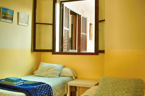 Ένα ή περισσότερα κρεβάτια σε δωμάτιο στο Hostal Atlanta
