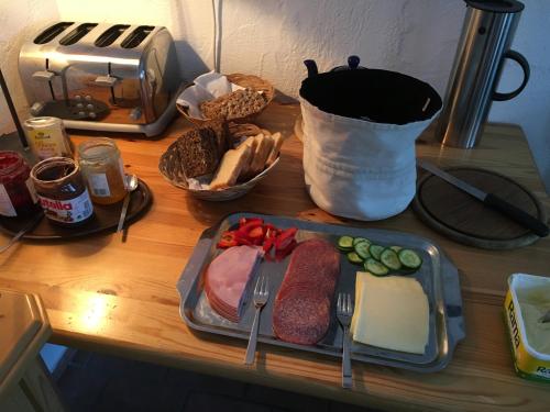 a table with a tray of meat and cheese and bread at Ski Lodge Jaktman in Bad Gastein