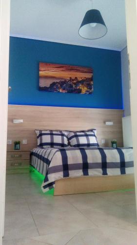 a bedroom with two beds and a blue wall at Amazing Apartment In The Center in Alexandroupoli