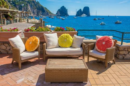 
a living room with a couch, chairs and a table at Diva La Canzone Del Mare in Capri
