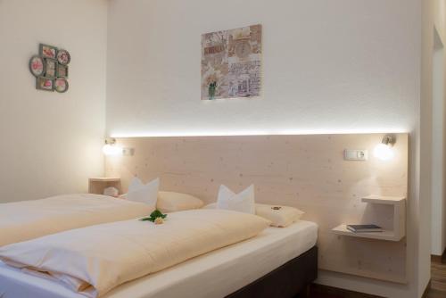 a bedroom with two beds with white sheets at Gasthof Stocker in Landsham