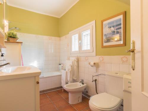 a bathroom with a white toilet and a sink at Los Prejones in Arenas de San Pedro
