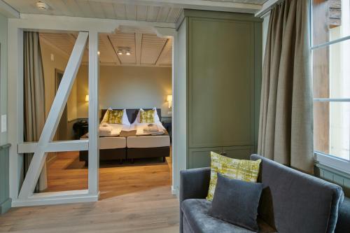a living room with a view of a bedroom at Hotel Spinne Grindelwald in Grindelwald