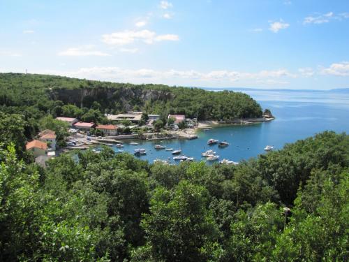 an island in the water with boats in it at Boarding House Lucija in Kostrena