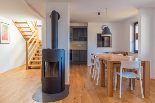 una cucina e una sala da pranzo con una stufa a legna di Villa Bohinca a Bohinj