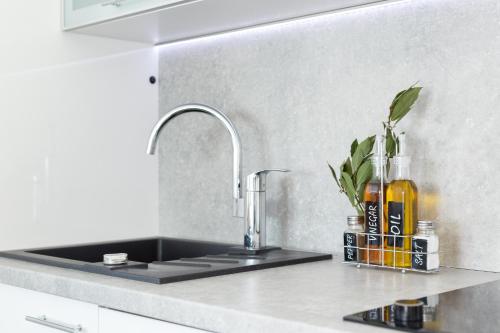 a kitchen counter top with a sink and a sink at Apartments M&L in Vodice