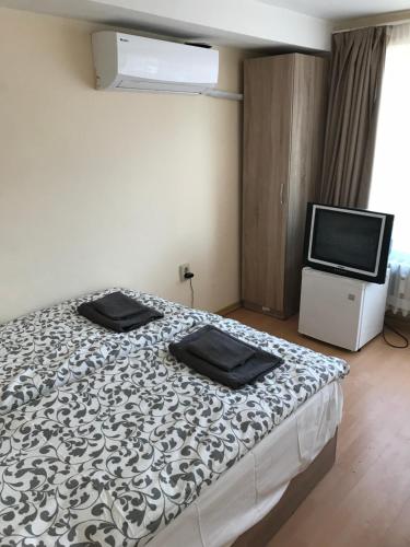 a bedroom with a bed and a flat screen tv at City Hostel Sofia in Sofia