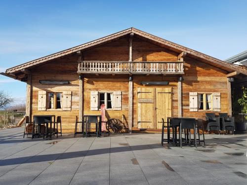 a woman standing in front of a log cabin at Köpfers Steinbuck in Bischoffingen