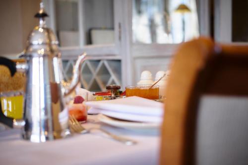 a table with a plate of food on top of it at Romantik Manoir Carpe Diem in De Haan