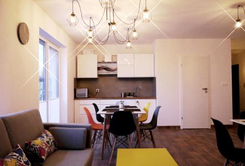 a living room and kitchen with a table and chairs at Obiekt Noclegowy OCELOT in Pruszków