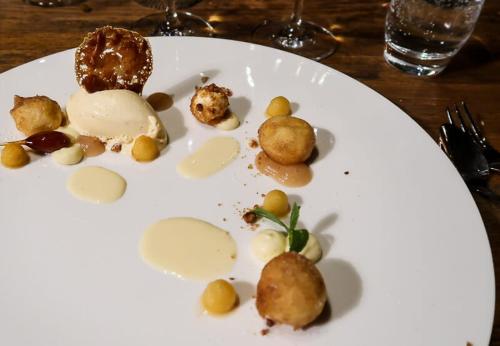 a white plate with some food on a table at Köpfers Steinbuck in Bischoffingen