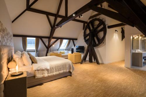 a bedroom with a large bed and a windmill at Hotel 'T Sandt in Antwerp