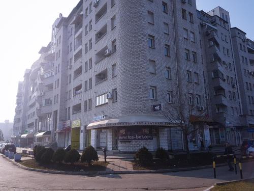a tall white building on a city street at Apartment Arena Silver in Belgrade