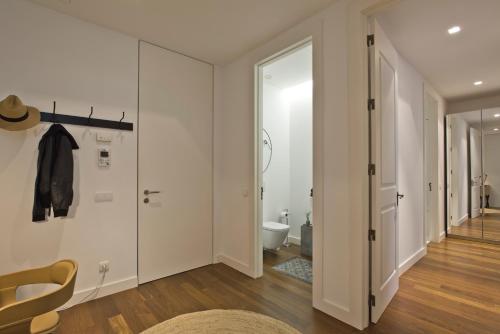 a white bathroom with a toilet and a hallway at Libest Av. da República 1 - Saldanha in Lisbon