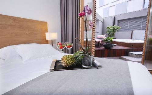 a hotel room with a bed with a tray with a pineapple on it at Luxury Apartment Kampanel in Split