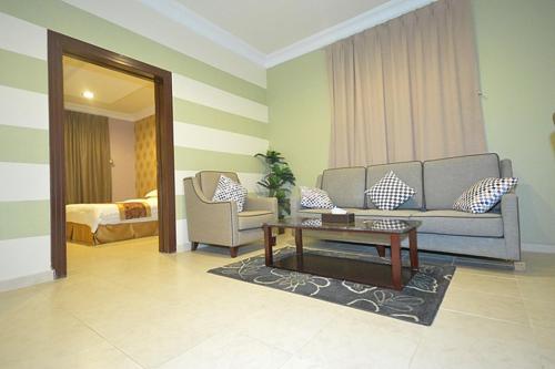 a living room with a couch and a coffee table at Araek Hotel Apartments in Ar Rass