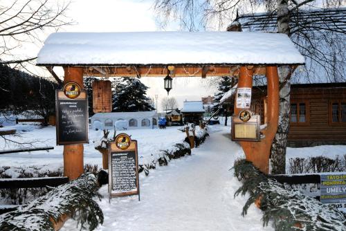 a gazebo with snow on top of it at Penzión Koliba in Dolný Kubín