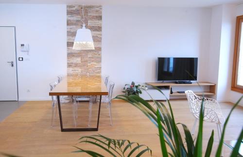 a dining room with a table and chairs and a tv at Luxury Apartment Kampanel in Split