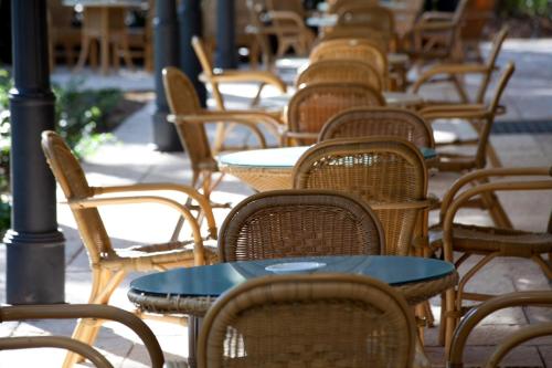 a row of tables and chairs on a patio at Villa Maria Hotel & SPA in Francavilla al Mare