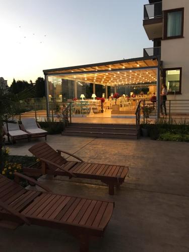 a group of benches in a patio with a restaurant at St. Panteleimon Beach Hotel in Nesebar