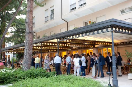 a group of people standing outside of a building at Villa Maria Hotel & SPA in Francavilla al Mare