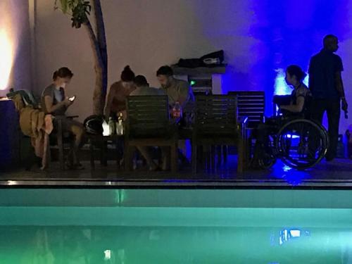 a group of people sitting at a table in a room at Villa 234 in Galle
