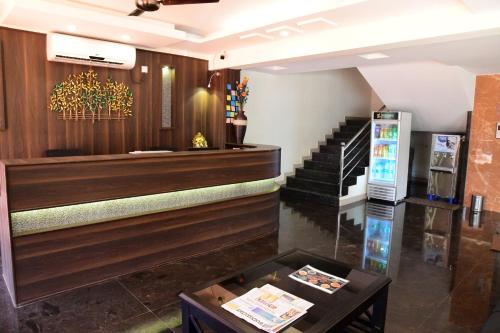 a lobby with stairs and a table in a room at Shesha KUTEERA in Subrahmanya