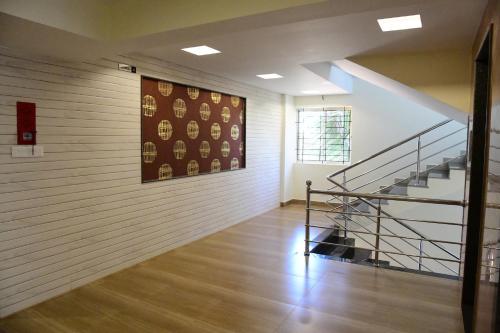 a room with a staircase and a painting on the wall at Shesha KUTEERA in Subrahmanya