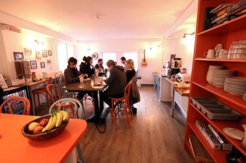 a group of people sitting at a table in a restaurant at Galway City Hostel - Solo Traveller Hostel in Galway