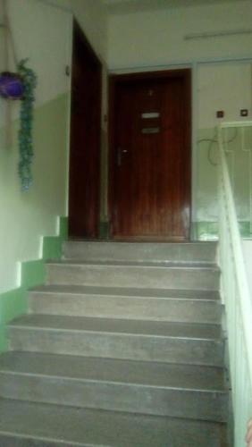a set of stairs in a building with a door at Fészek Apartman in Békéscsaba