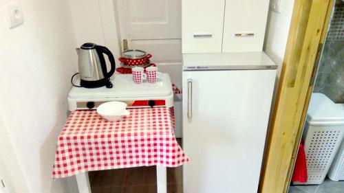 a kitchen with a red and white checkered table cloth at Apartmani Bosco in Tivat