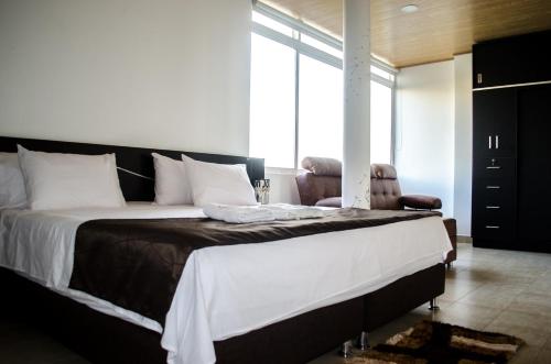 a bedroom with a large bed and a window at Hotel Quinta del Sol in Arauca