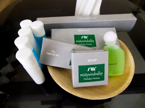 a plate with two bottles of mouthwash and a box of medicine at Mistywindvalley in Kudayattūr