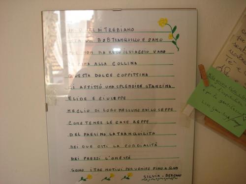 a menu for a restaurant with a flower on the wall at Da Giusè in Trebiano