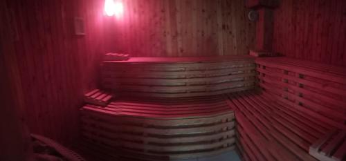 a red room with a sauna with red lighting at Vencsellői Wellness Vendégház in Gávavencsellő