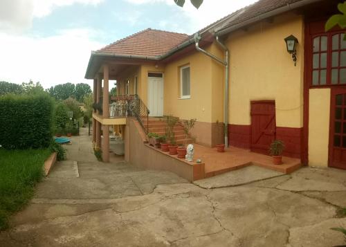 a house with a porch and a patio at Vencsellői Wellness Vendégház in Gávavencsellő