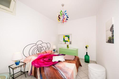1 dormitorio con 1 cama con una pintura en la pared en Villa Laura amazing breakfast,private outdoor hot tub, Positano experience, en Positano