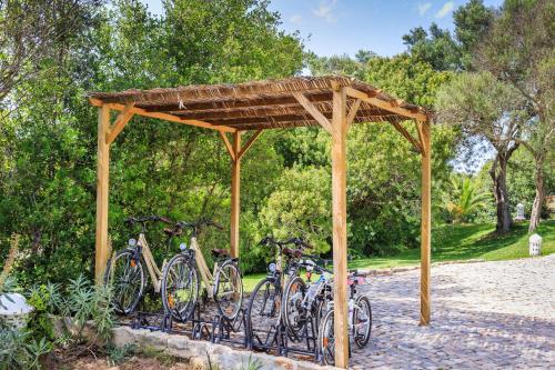 a group of bikes parked under a wooden structure at Octant Vila Monte in Moncarapacho
