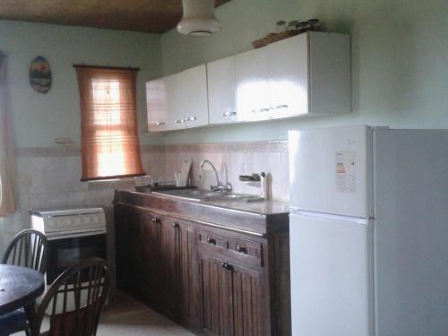 a kitchen with a sink and a white refrigerator at apto con vista al mar in La Paloma