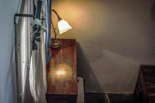 a lamp sitting on a table next to a window at Giannakas Studios in Platis Yialos Sifnos