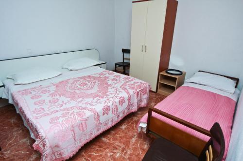 a bedroom with two beds and a chair in it at Robinson Apollon in Gdinj