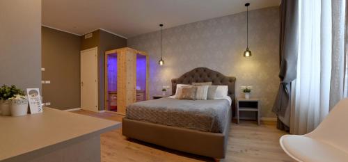 a bedroom with a bed and a purple window at Lainez Rooms & Suites in Trento