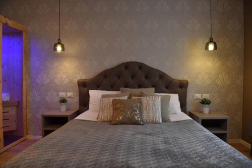 a bedroom with a large bed with two night stands at Lainez Rooms & Suites in Trento