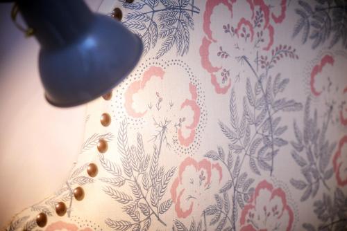 a curtain with red and white flowers on it at Embankment Hotel in Bedford