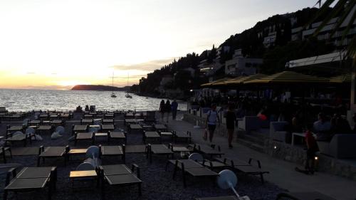 a group of chairs and tables on the beach at Ana Guesthouse in Dubrovnik
