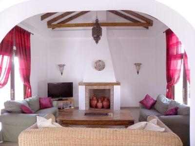 a living room with a couch and a fireplace at Casa Laura in Almuñécar