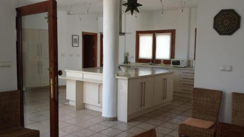 a kitchen with a counter and a column in it at Casa Laura in Almuñécar