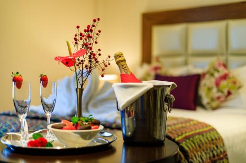 a table with a plate of food and a bottle of champagne at Grand Hotel Tralee in Tralee