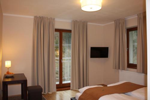 ein Hotelzimmer mit einem Bett und einem Fenster in der Unterkunft Villa Malina in Oščadnica